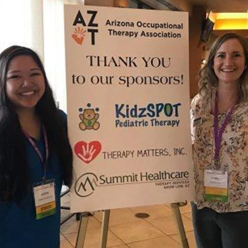 Image of two women standing on the sides of the 'Thank You To Our Sponsors' poster.